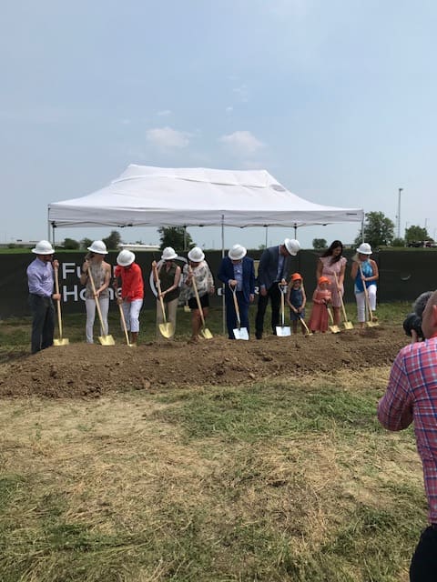 Groundbreaking ceremony — H+H leadership in hard hats with golden shovels at a new site